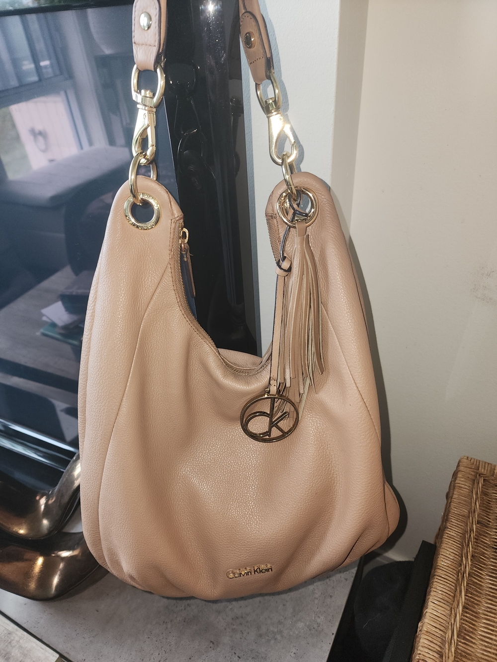 Calvin Klein Nude pebbled leather hobo with tassel and logo charm